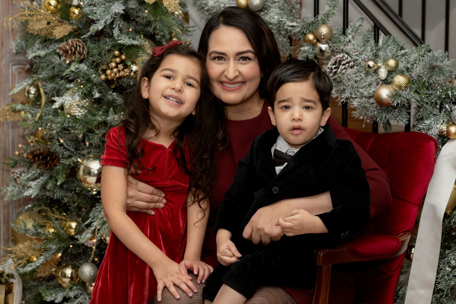 Family holiday portrait with Christmas decor and formal wear.