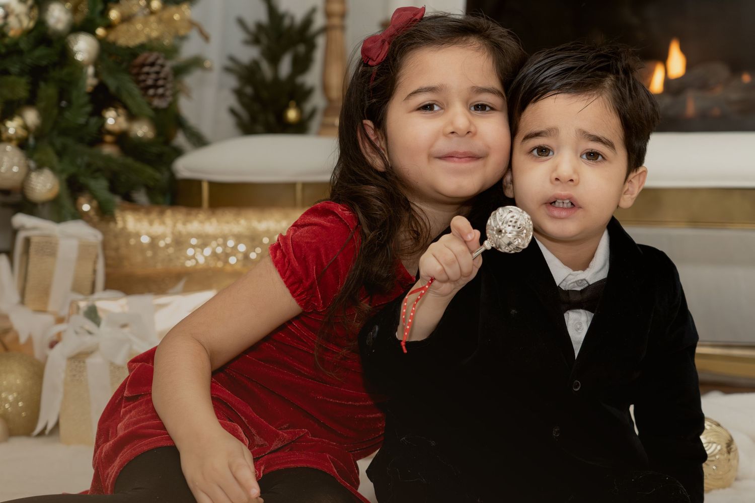 Family poses in formal attire for Christmas holiday photos.
