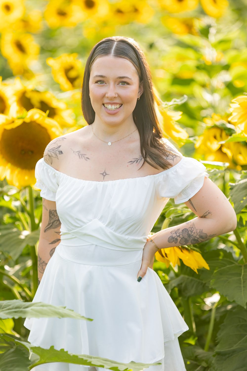 woman stylist wearing white and denim in sunflower field in clayton new jersey monroeville at sunset