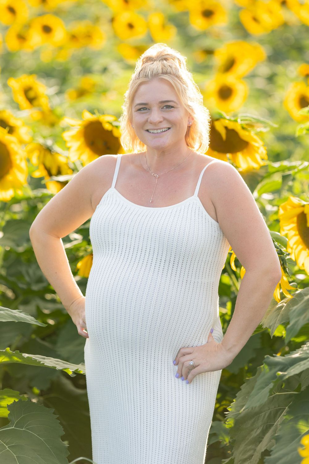 woman stylist wearing white and denim in sunflower field in clayton new jersey monroeville at sunset