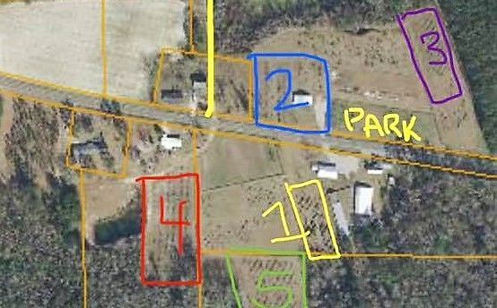 Aerial map view showing color-coded parcel zones with numbered sections and a park area.