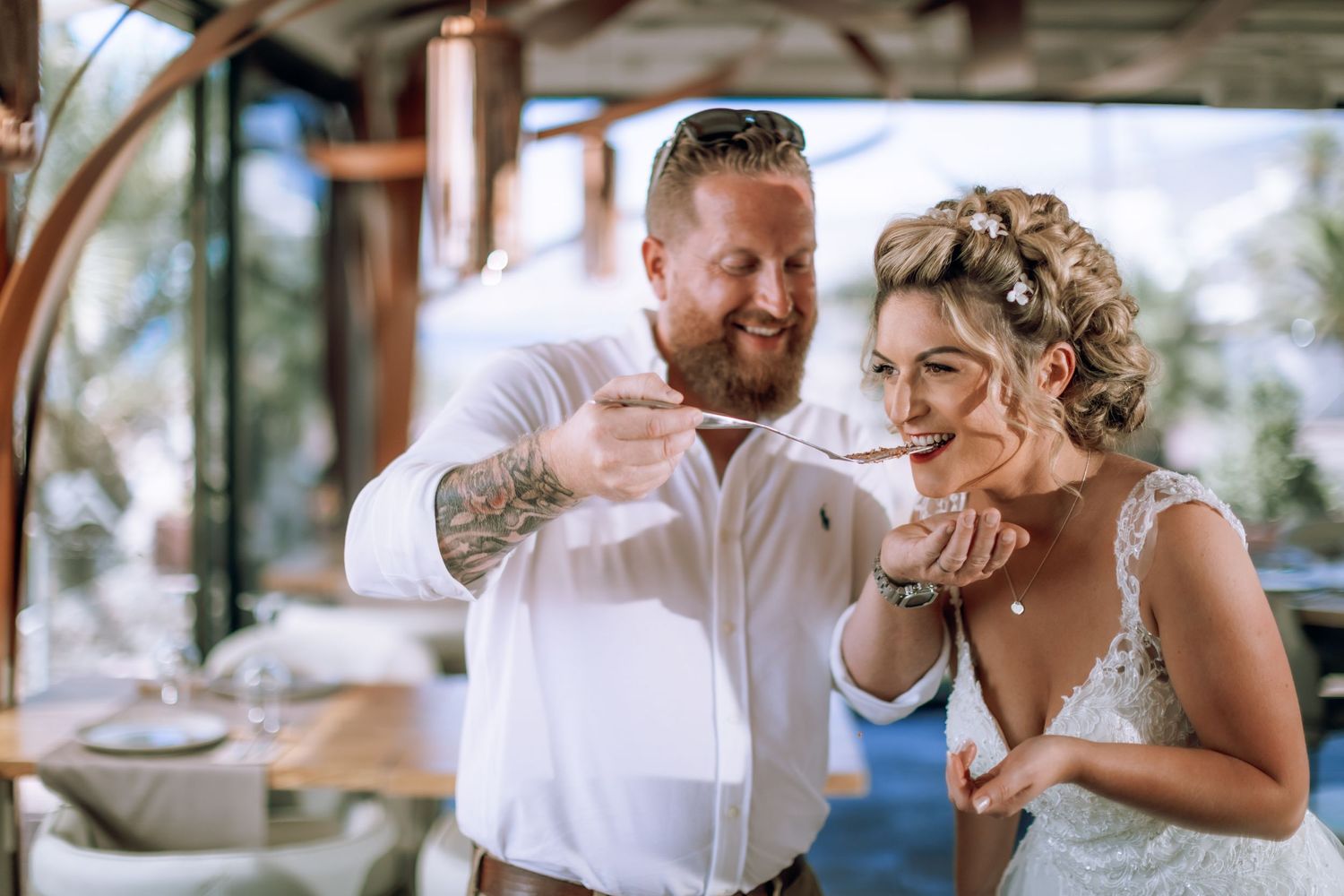 Authentic moment of tasting the cake between bride and groom.
