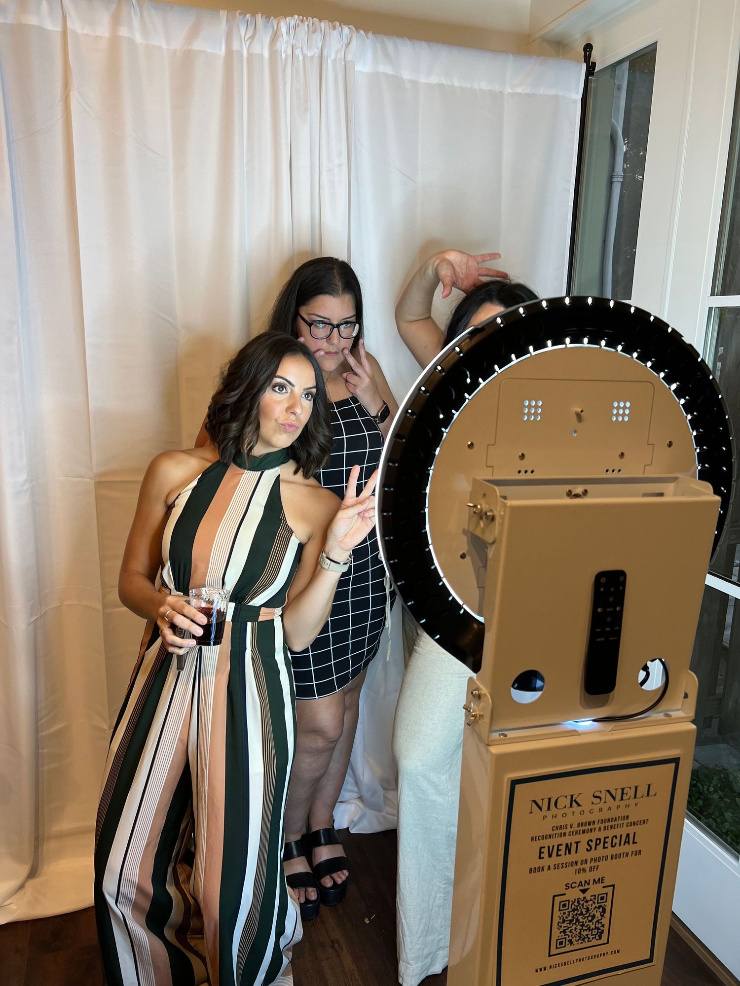 three women in front of photo booth