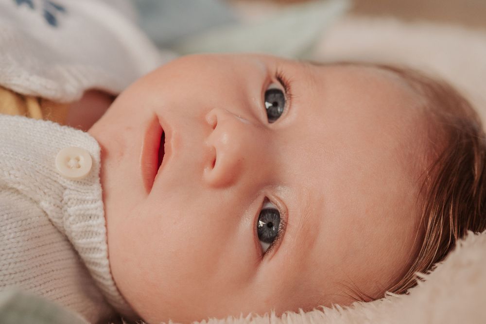 Close up portrait of baby with bright blue eyes.