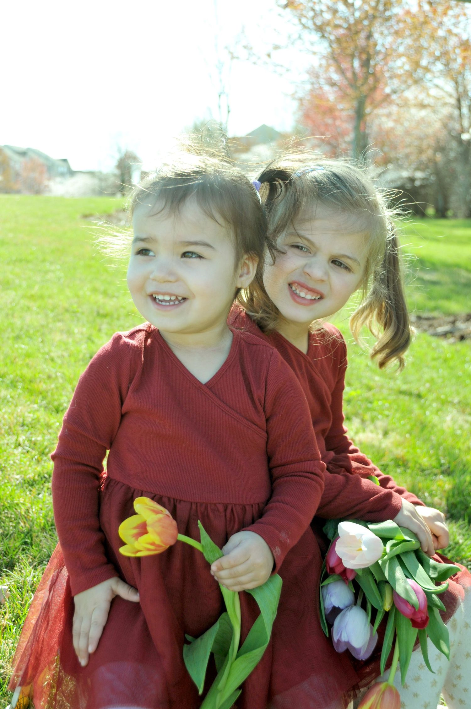 outside photograph of two sisters with tulips