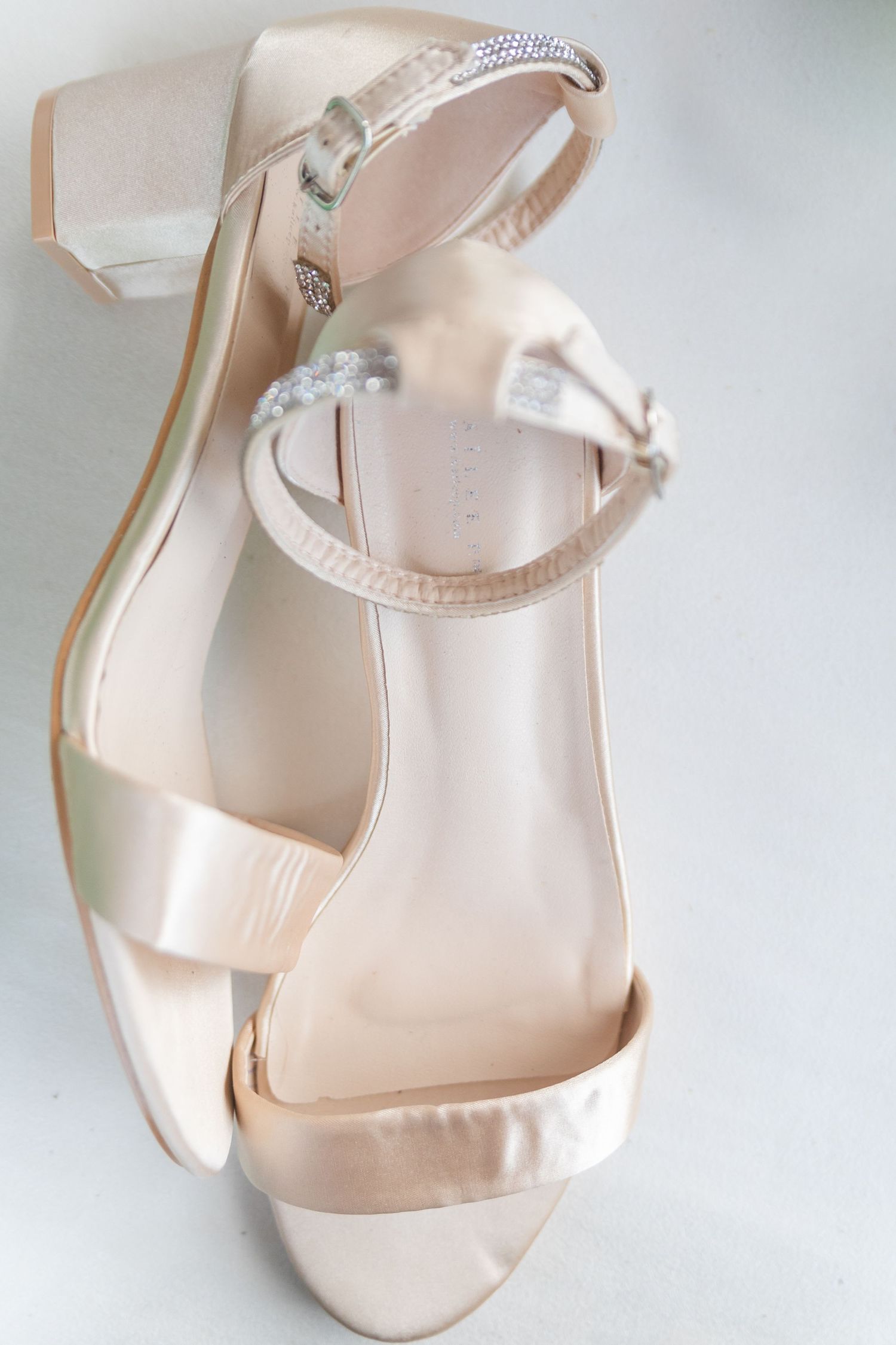 Elegant nude-colored bridal sandals with ankle straps displayed in multiple angles.