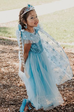 Magical blue princess dress with snowflake details and flowing cape.
