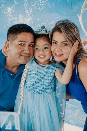 Family celebration against a sparkly blue winter wonderland backdrop.