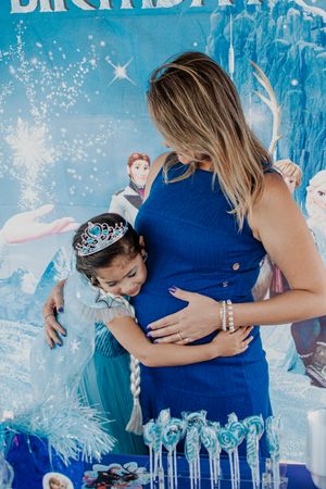 Winter themed party scene with blue decorations and twinkling lights.