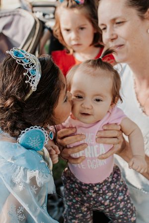 Close-up of people wearing festive attire at outdoor celebration.