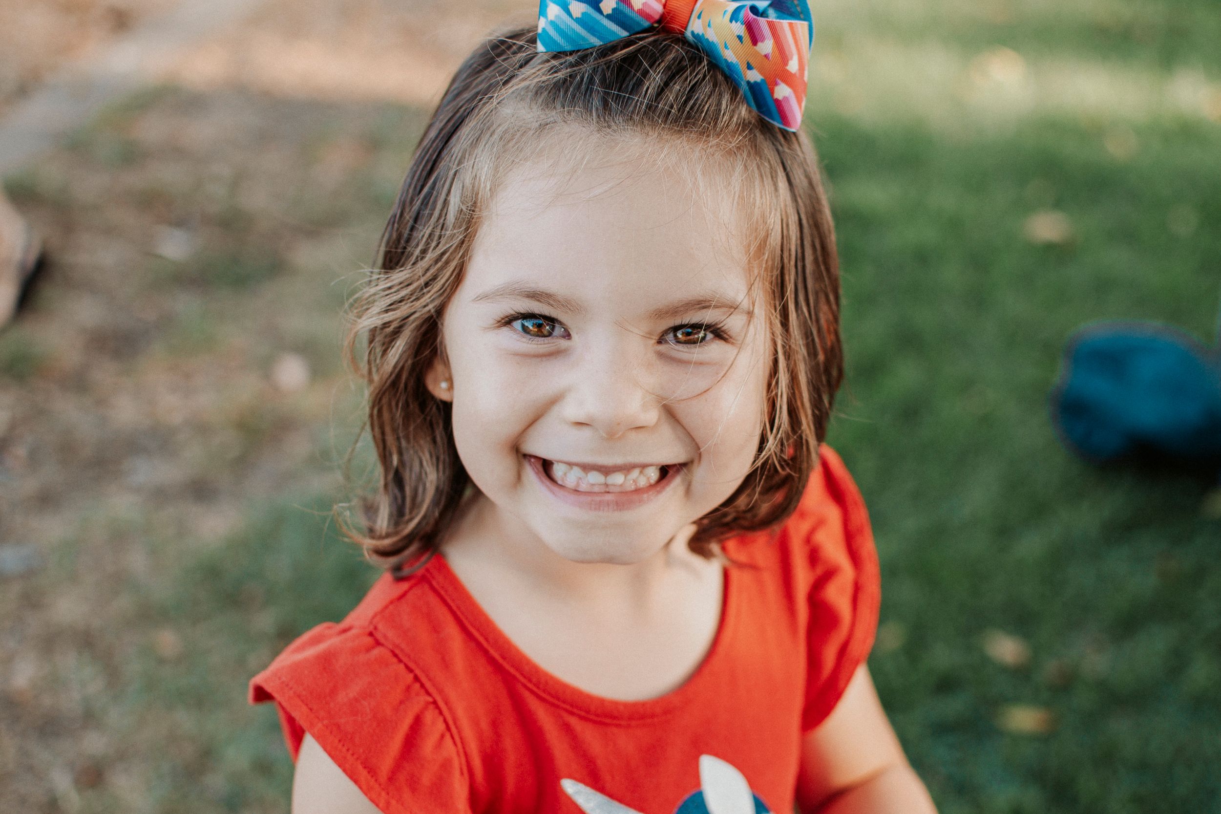 A bright smile captured in an outdoor portrait shot.