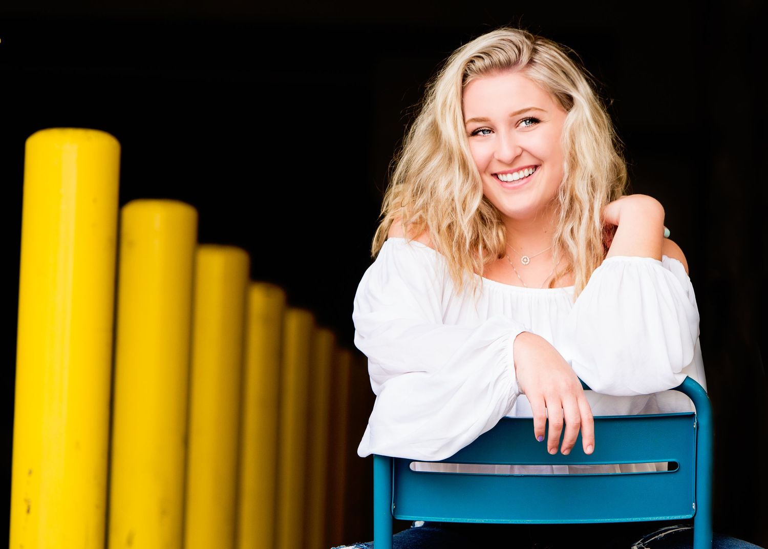 Senior girl photo sitting in blue chair
