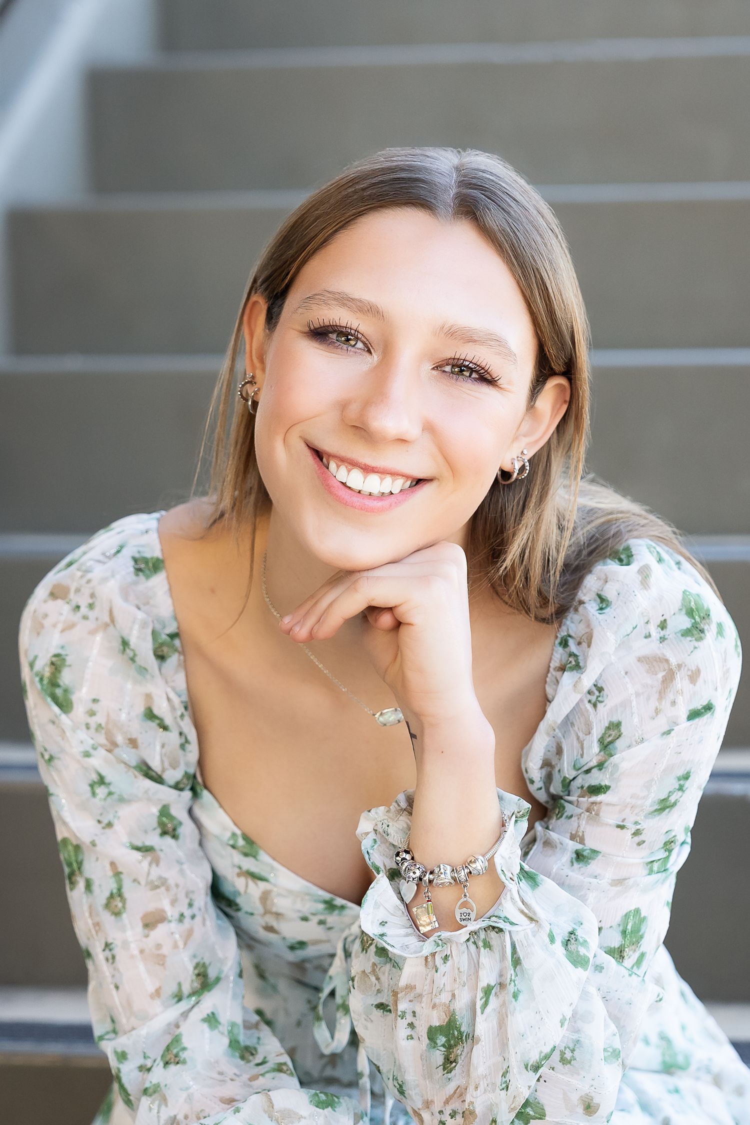 portrait of high school senior girl in white dress with green floral