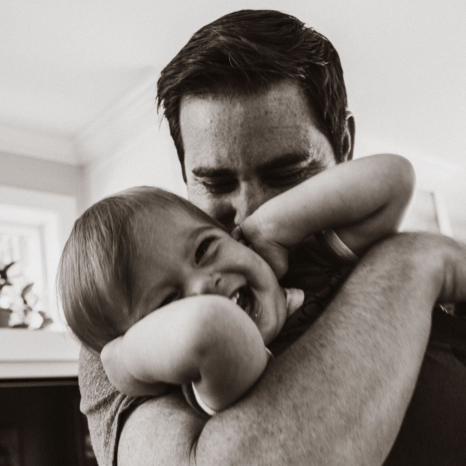 dad hugging a laughing child