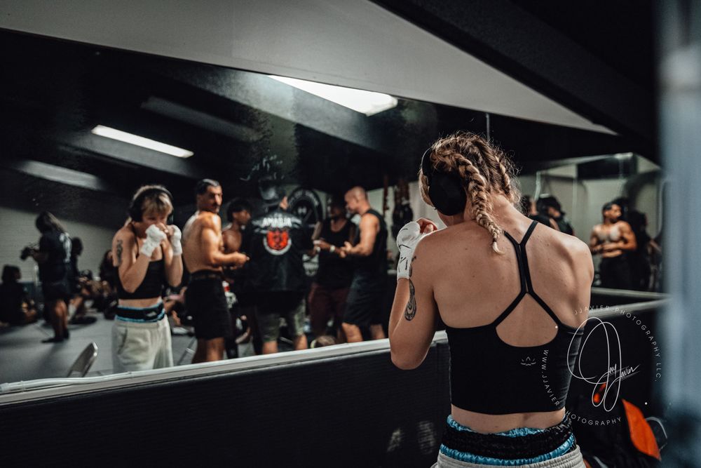 Athletes practicing martial arts moves in a modern training facility.