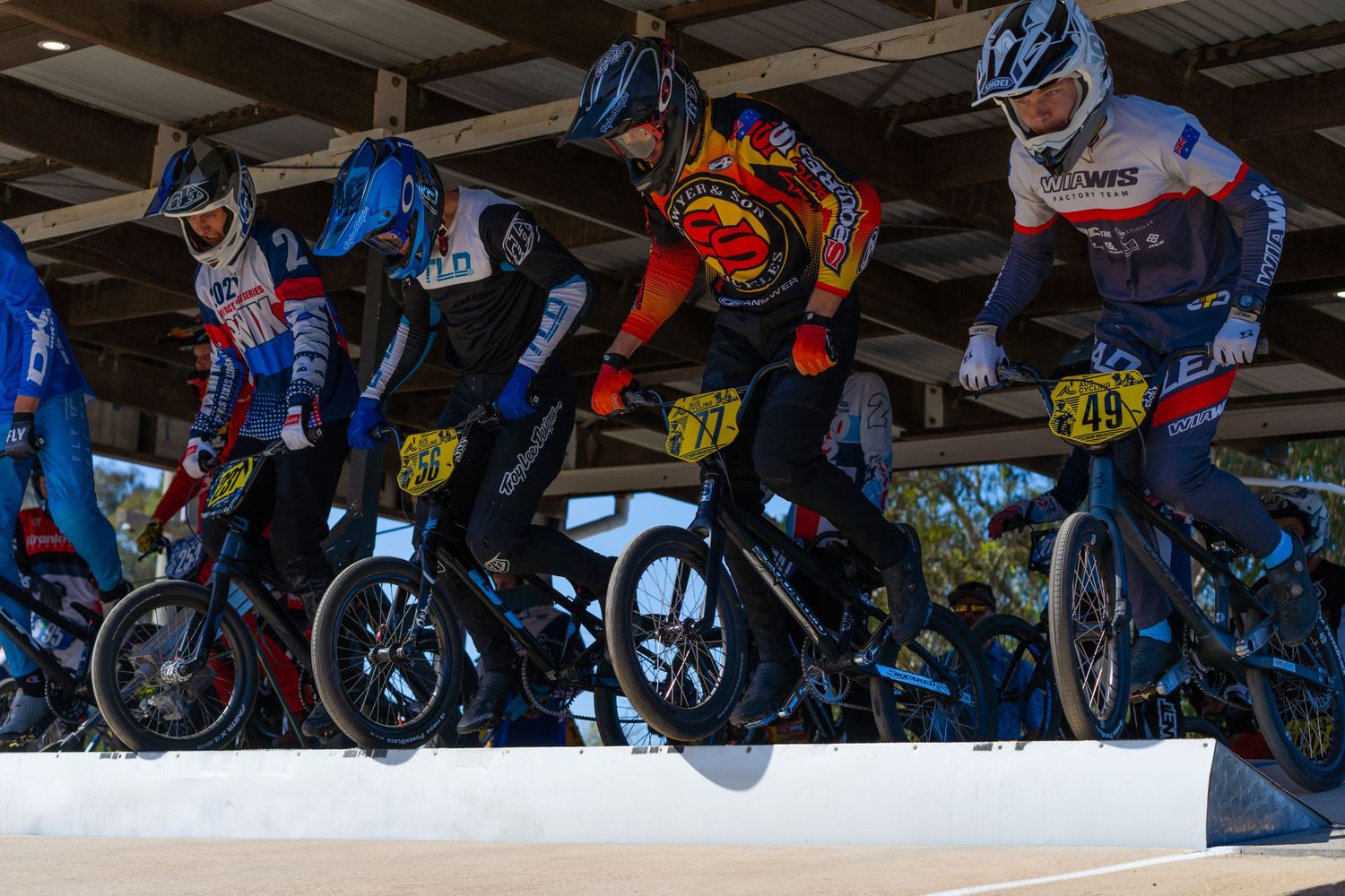 BMX riders line up at the starting gate during a race competition.