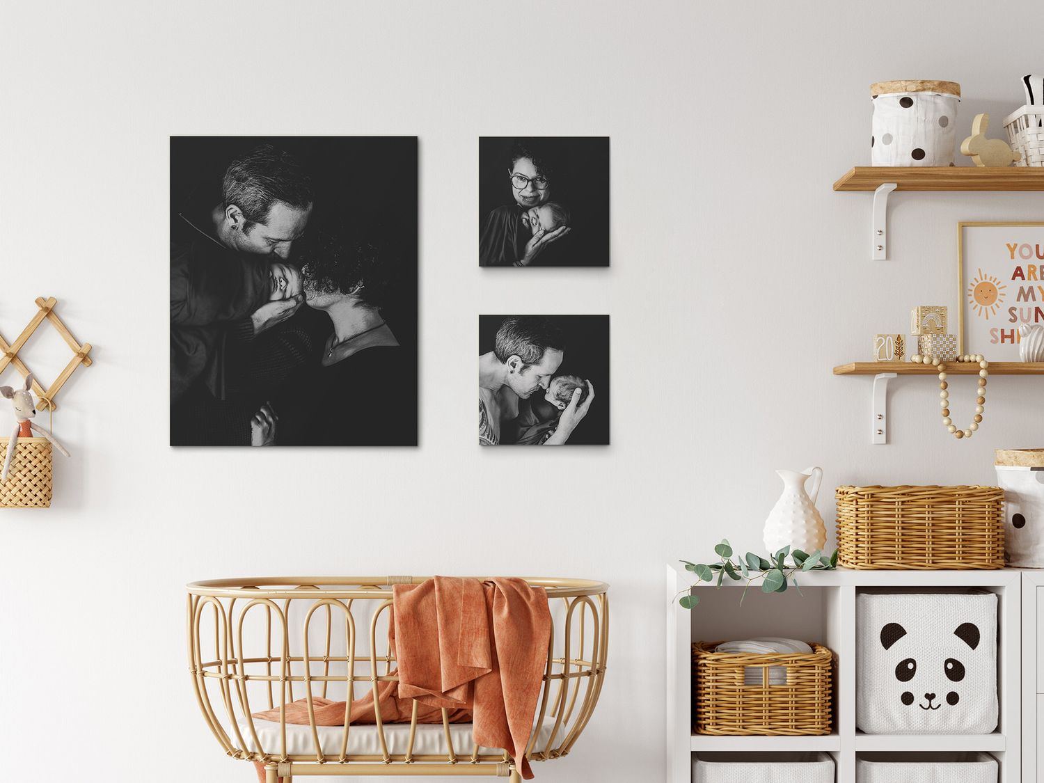 Monochrome gallery wall above rattan crib with woven baskets and panda storage in nursery.