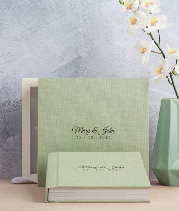 Sage green photo album with elegant script text and white orchid decoration.