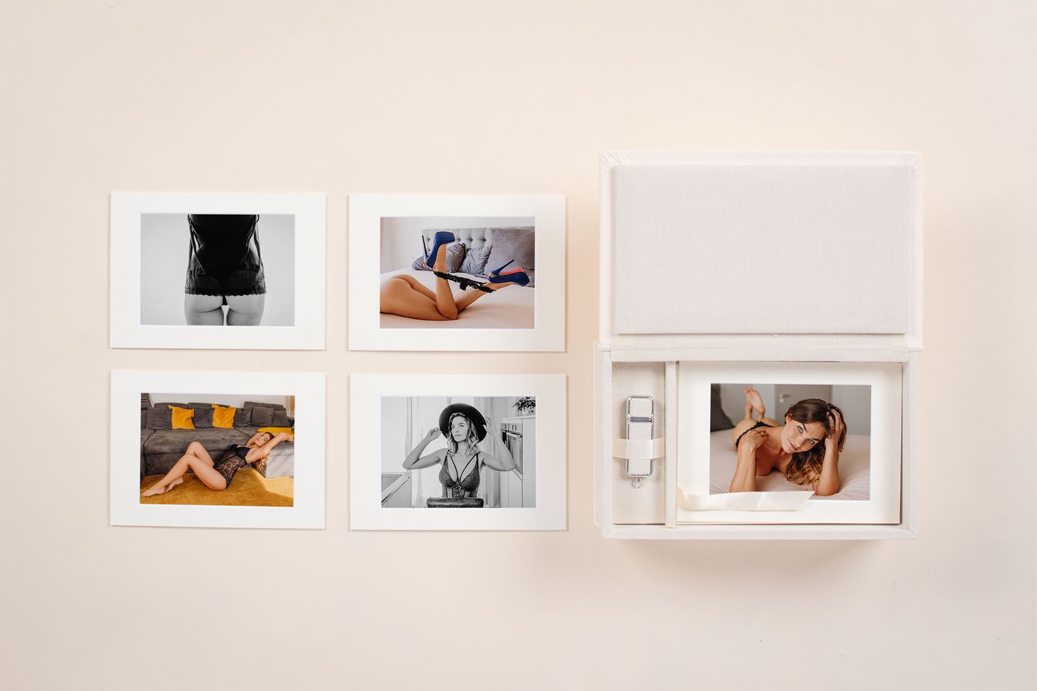 Gallery wall display of framed photographs in white matting against neutral wall.