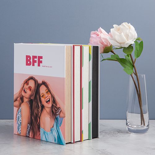Photo book titled BFF with roses in vase against blue background.