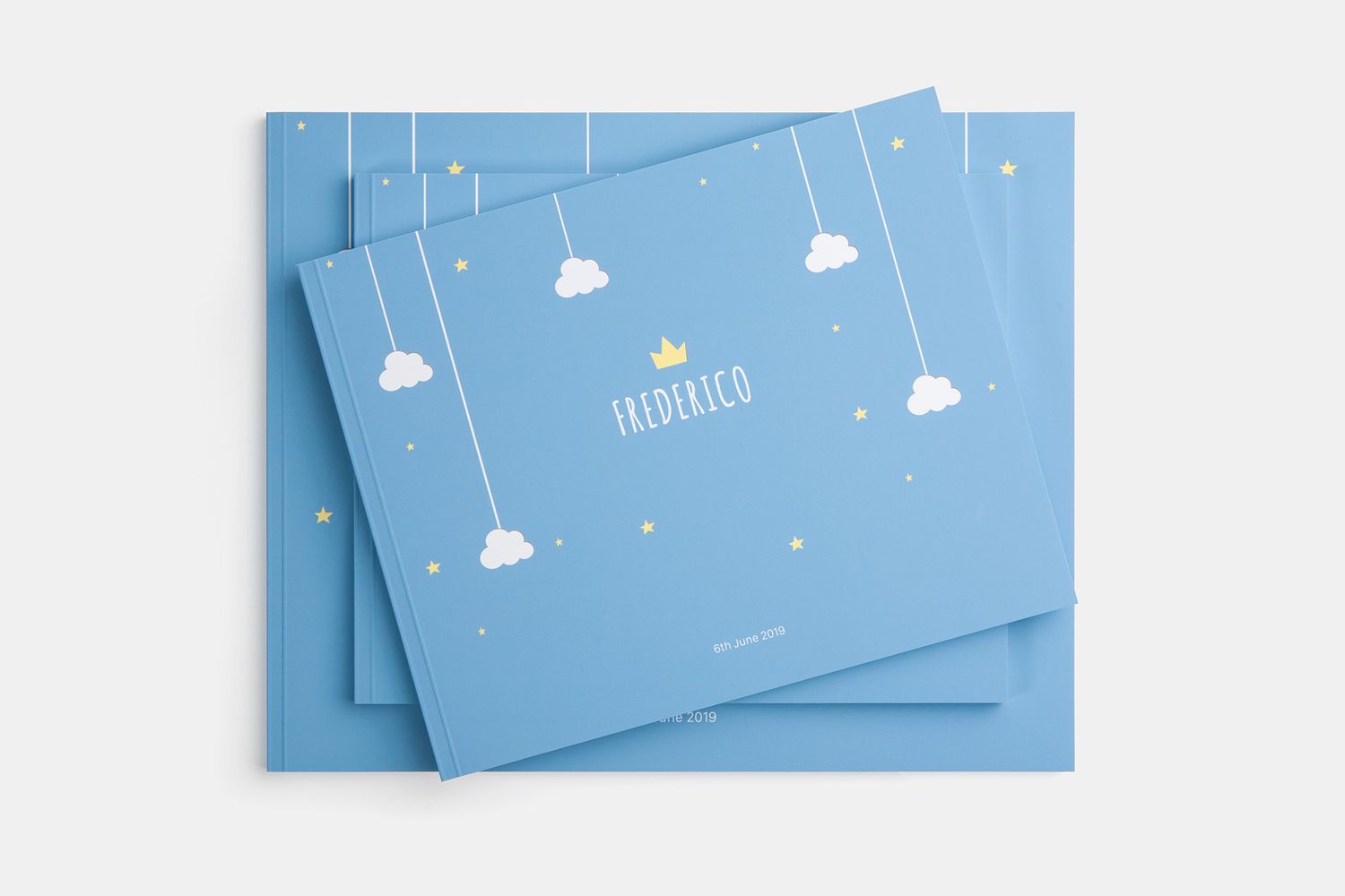 Blue photo album cover with cute cloud and star illustrations.