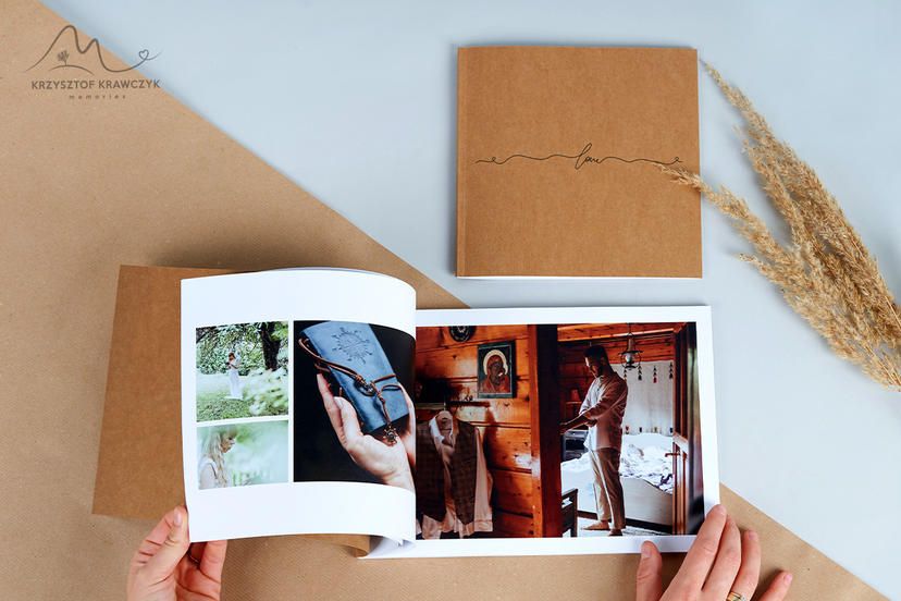 An open photo album showing wedding day memories with dried wheat grass decoration.