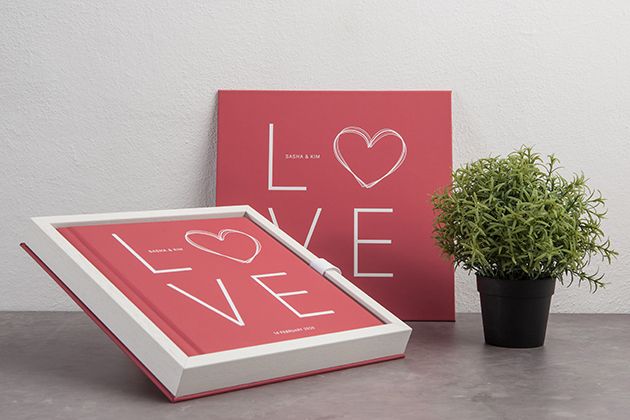 Modern love-themed wall art prints in coral red featuring minimalist heart typography design.