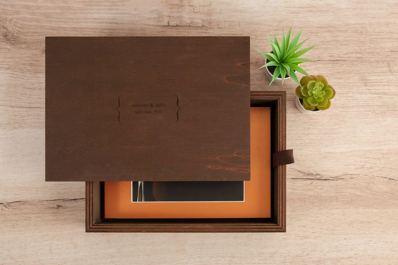 A sleek brown wooden box with minimalist design and small succulent plants as decoration.