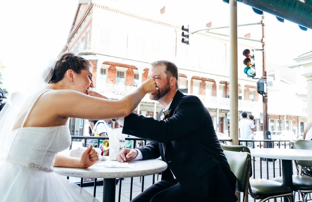 A newly wed couple shares their first beignets as husband and wife.