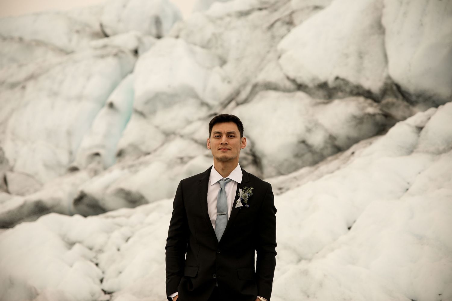 Groom posing in front of the Matanuska Glacier