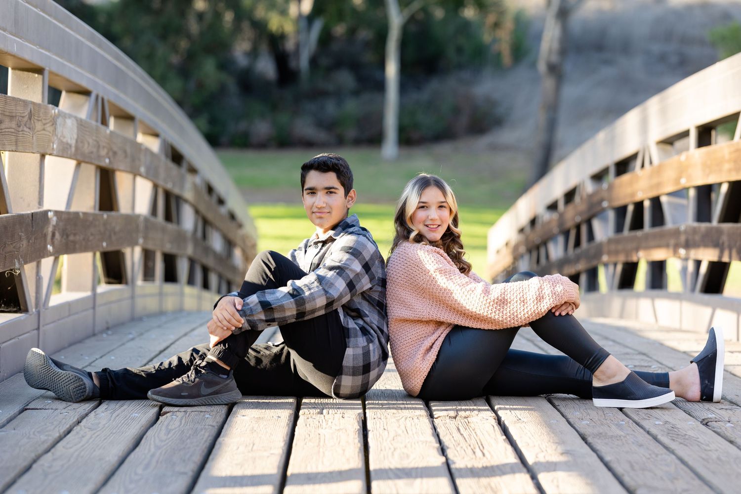 Brother and sister portrait session on a bridge at Laguna Niguel Regional Park