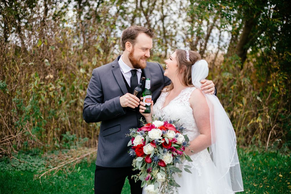 Bride and groom enjoying a beer on their wedding day