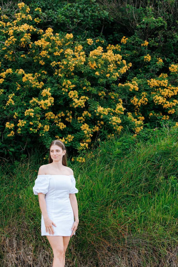 engagement photo of girl with yellow flowers in the background