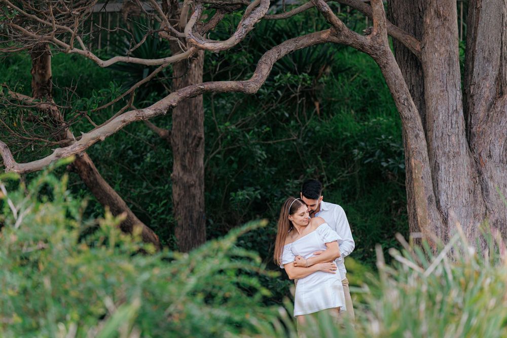 love couple hugging between the trees