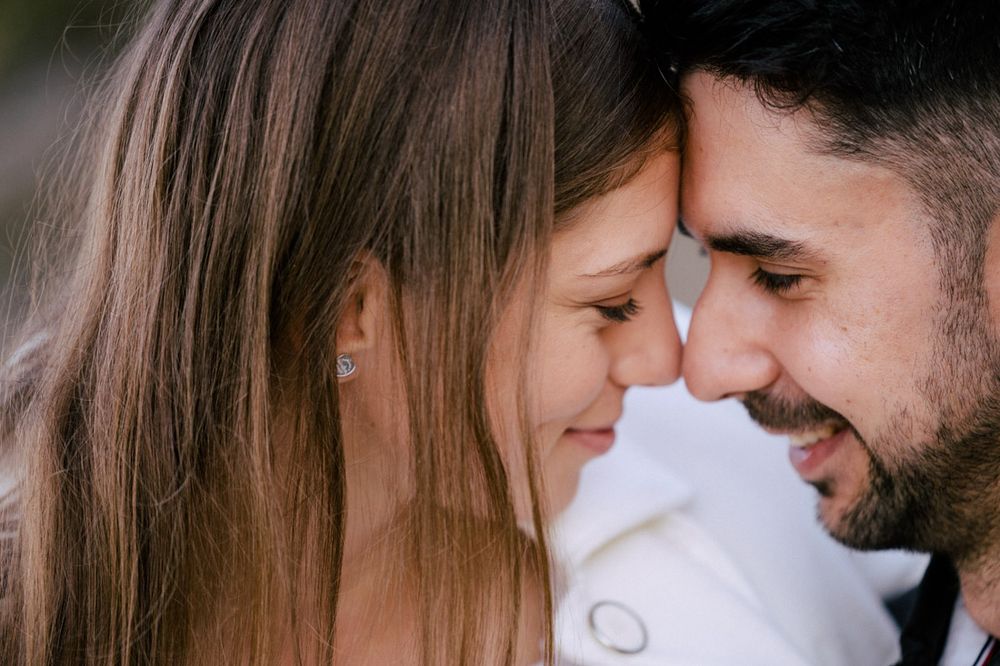 Close-up romantic moment captured between two people outdoors.