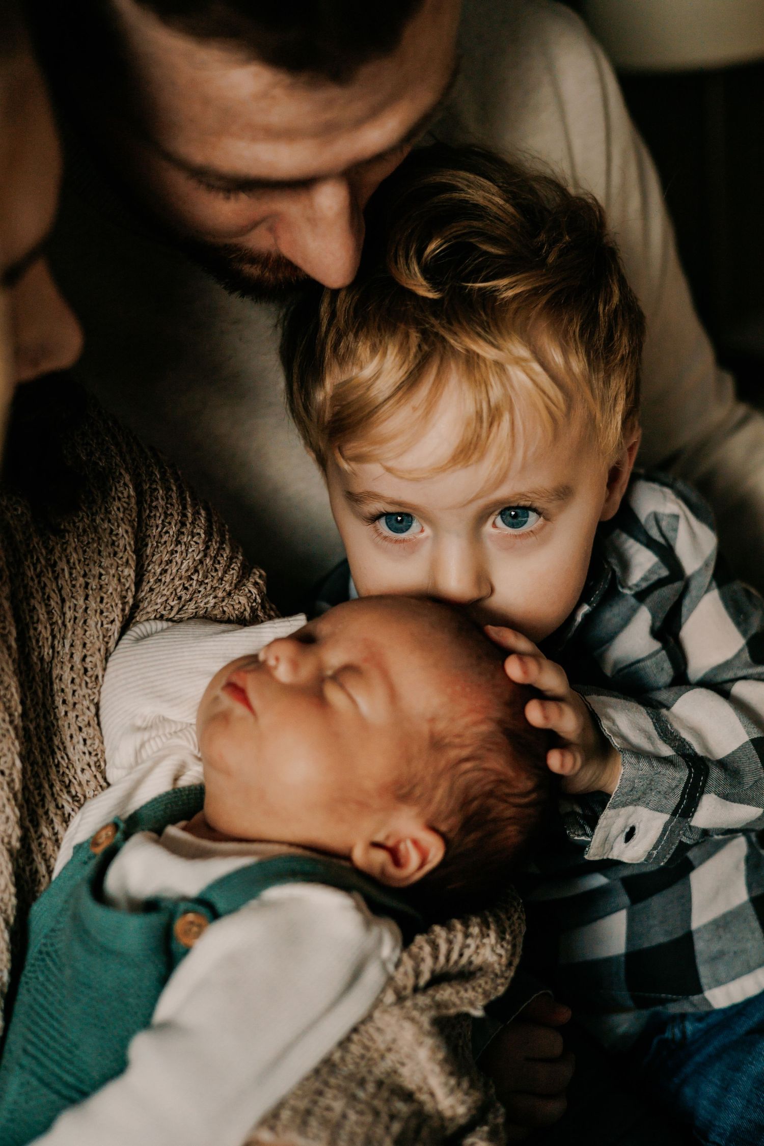 Tender family moment showing children and parent bonding together in soft natural light.