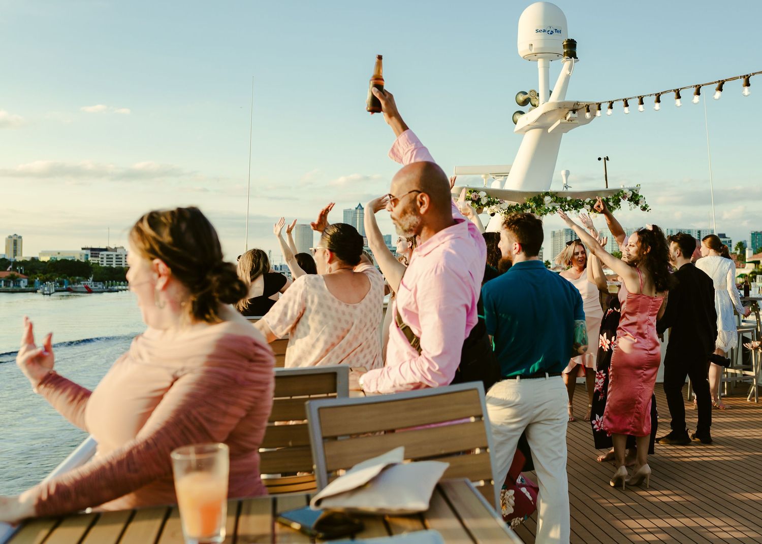 guests celebrating with their drinks up in the air