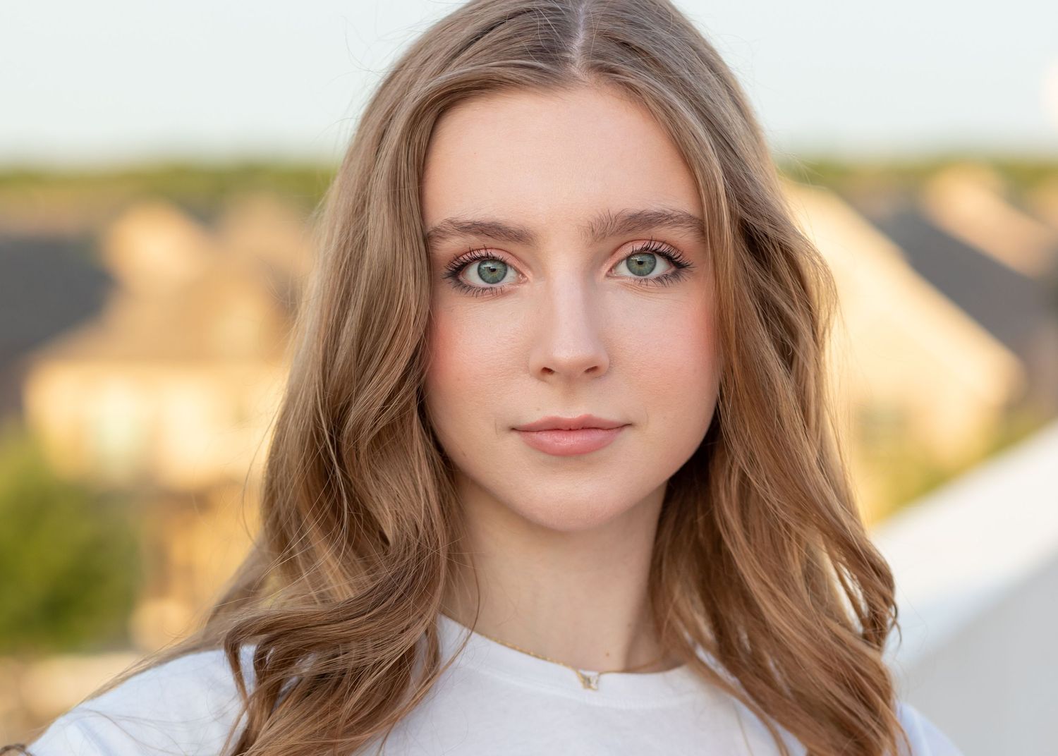 Close-up portrait with soft lighting highlighting natural features and warm smile.
