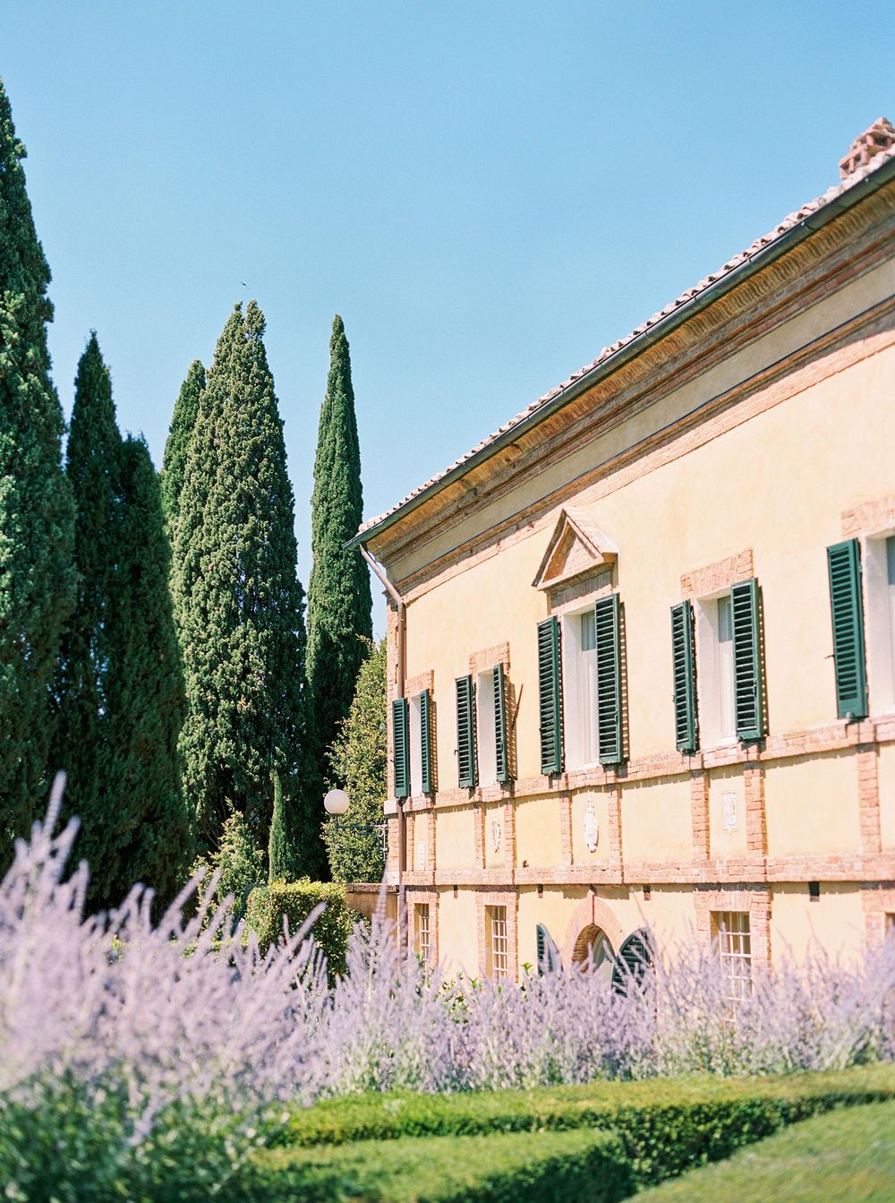 A picturesque Tuscan landscape with rolling hills, cypress trees, and a charming villa nestled in the countryside.