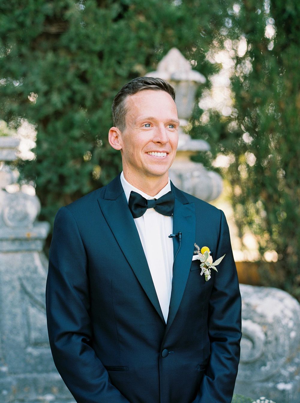 A groom in a tuxedo at La Foce.