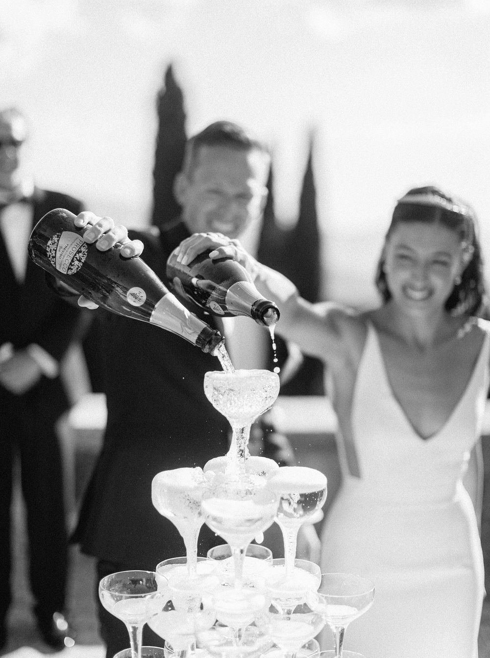A bride and groom celebrating with champagne at their wedding.