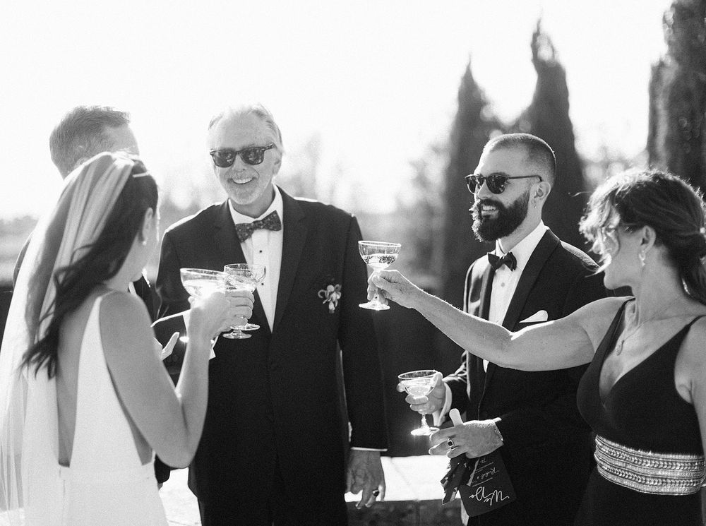 A bride and groom celebrating with champagne at their wedding.