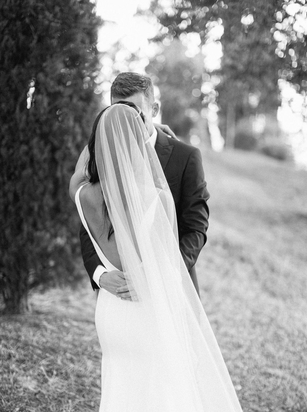 Elegant black and white wedding photography capturing the beautiful bride and groom on their special day.