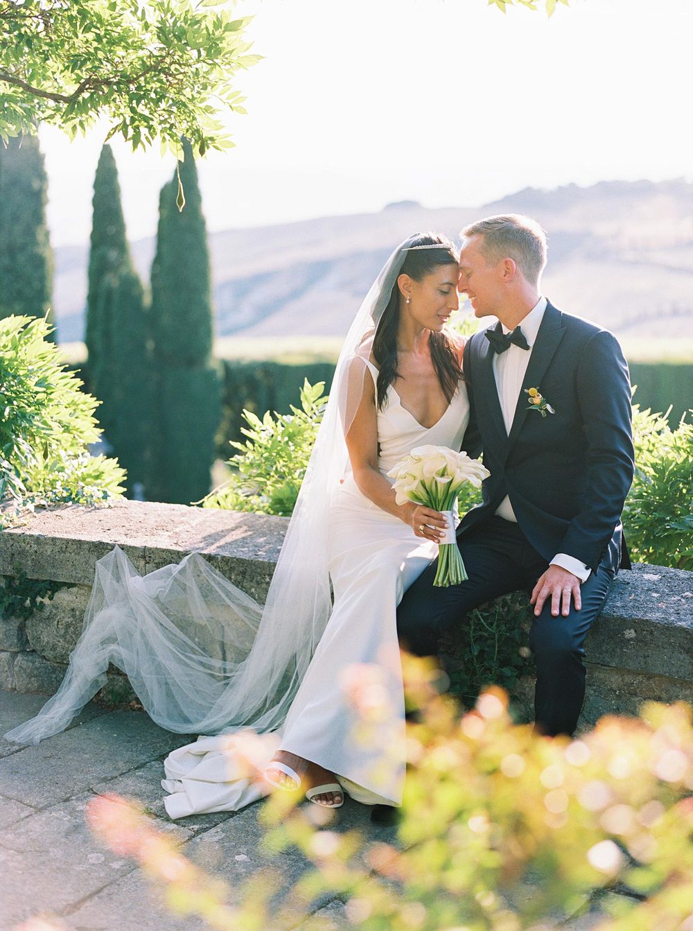 Newlyweds embracing in the picturesque La Foce, Tuscany.