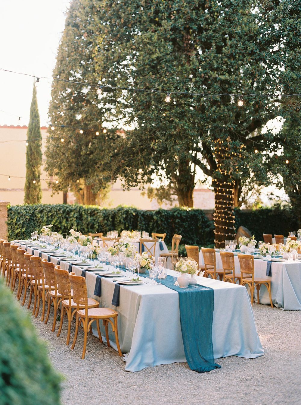 Wedding table adorned with flowers and candles in La Foce, Tuscany.