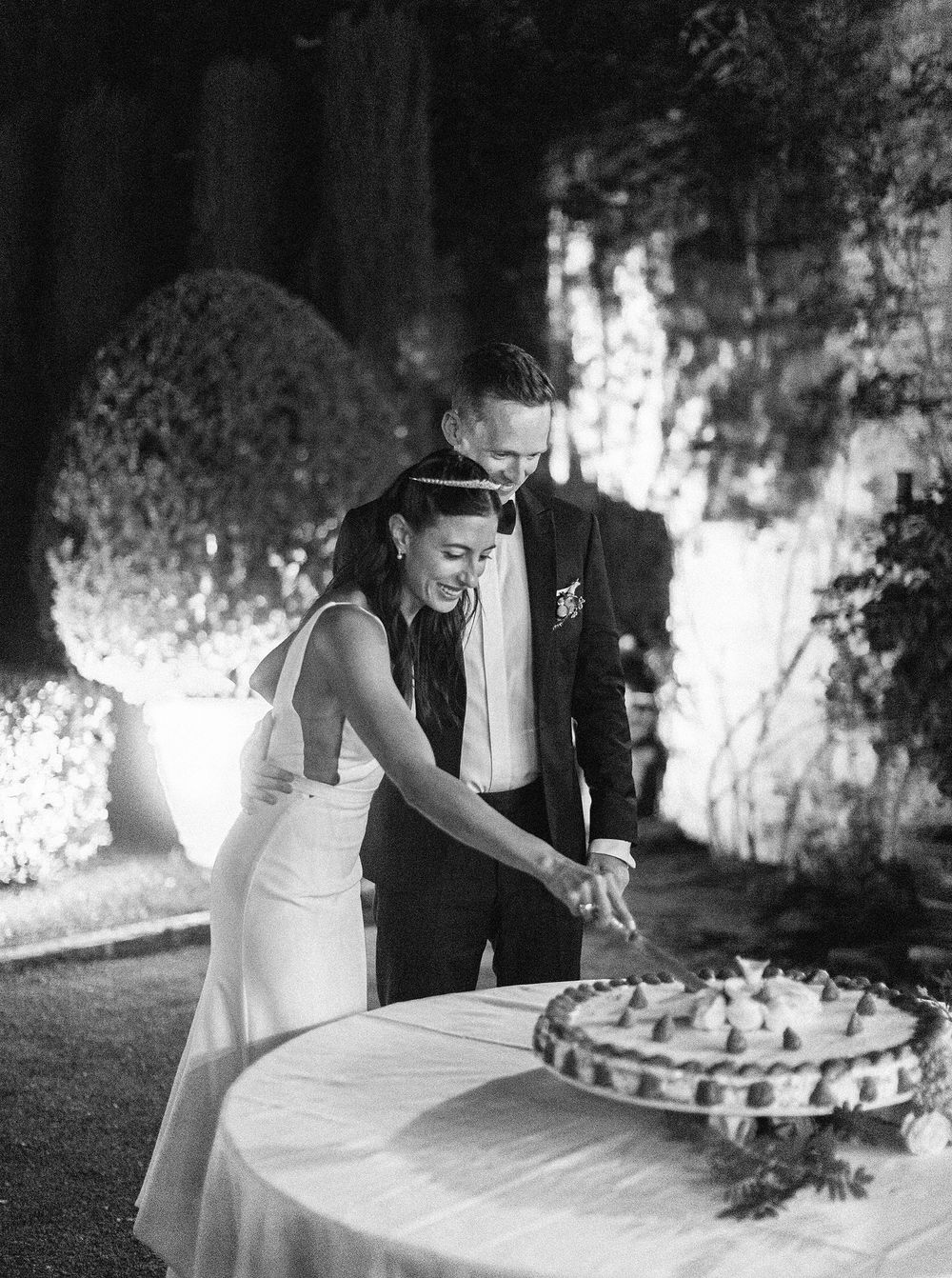 A joyful couple celebrating their wedding day by cutting a beautiful wedding cake together.