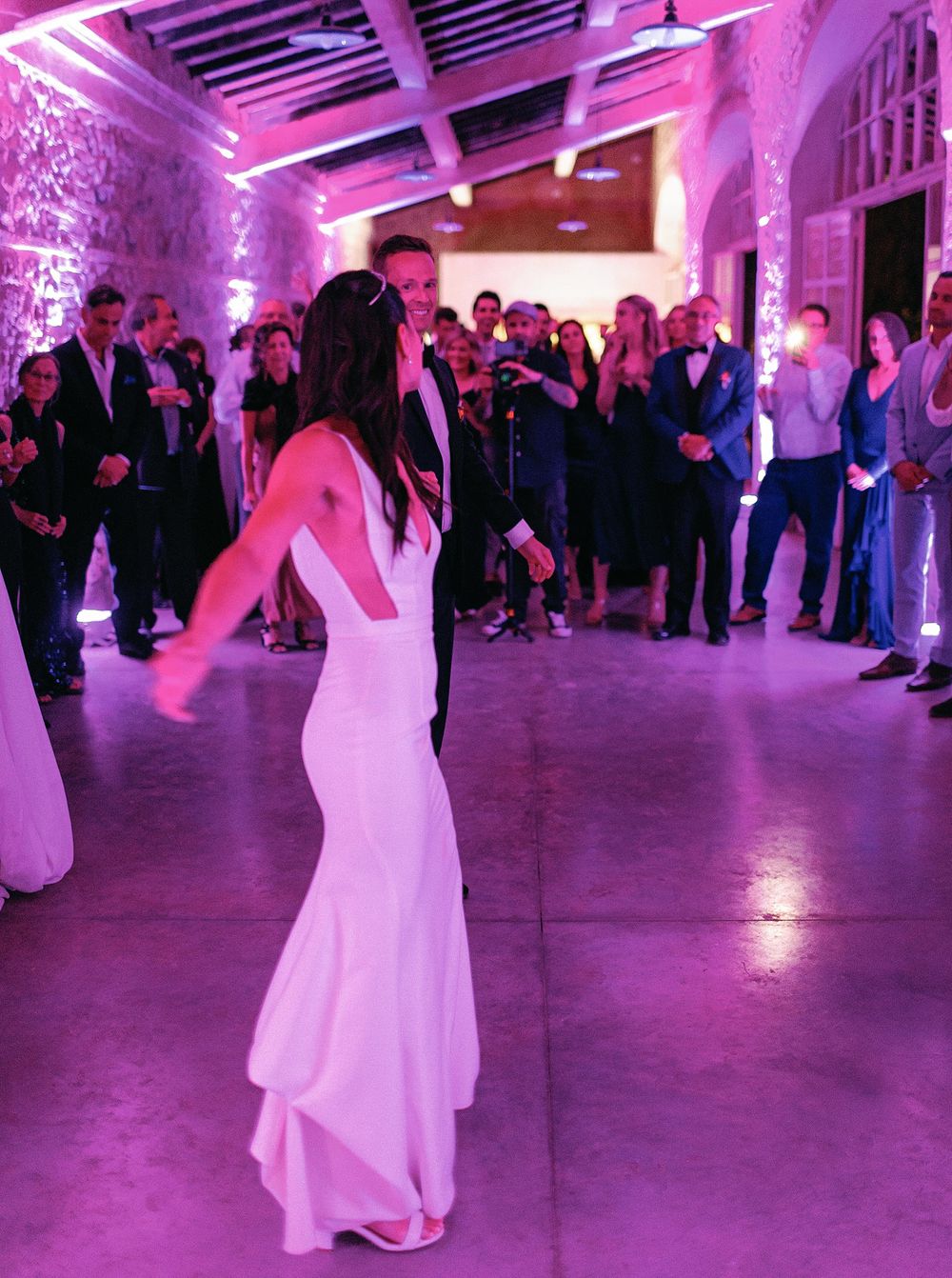 A newlywed couple gracefully dancing at their wedding reception in La Foce, Tuscany.