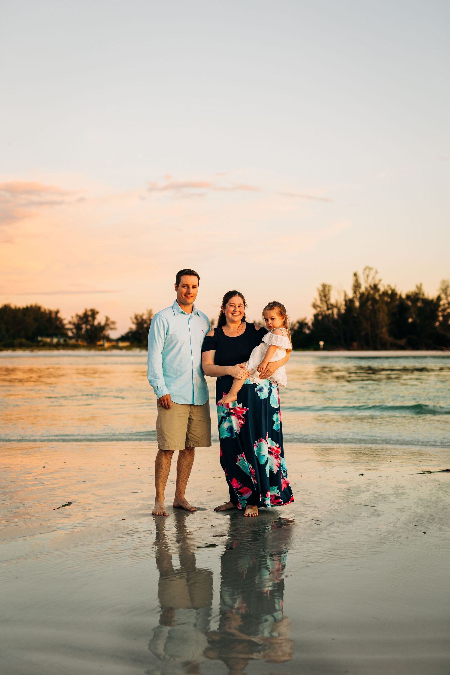 Family standing on the shore at sunset on Coquina Beach photographed by Sarasota Family Photographer.