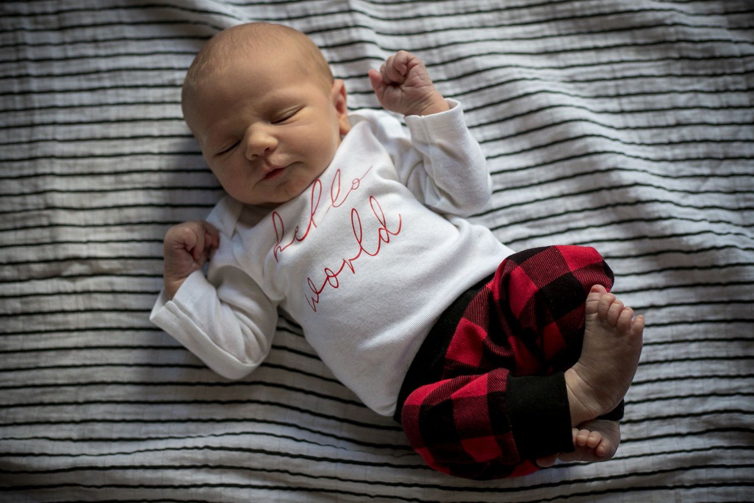 Newborn baby boy laying on his blanket during his in-home newborn session in Sioux City, IA.