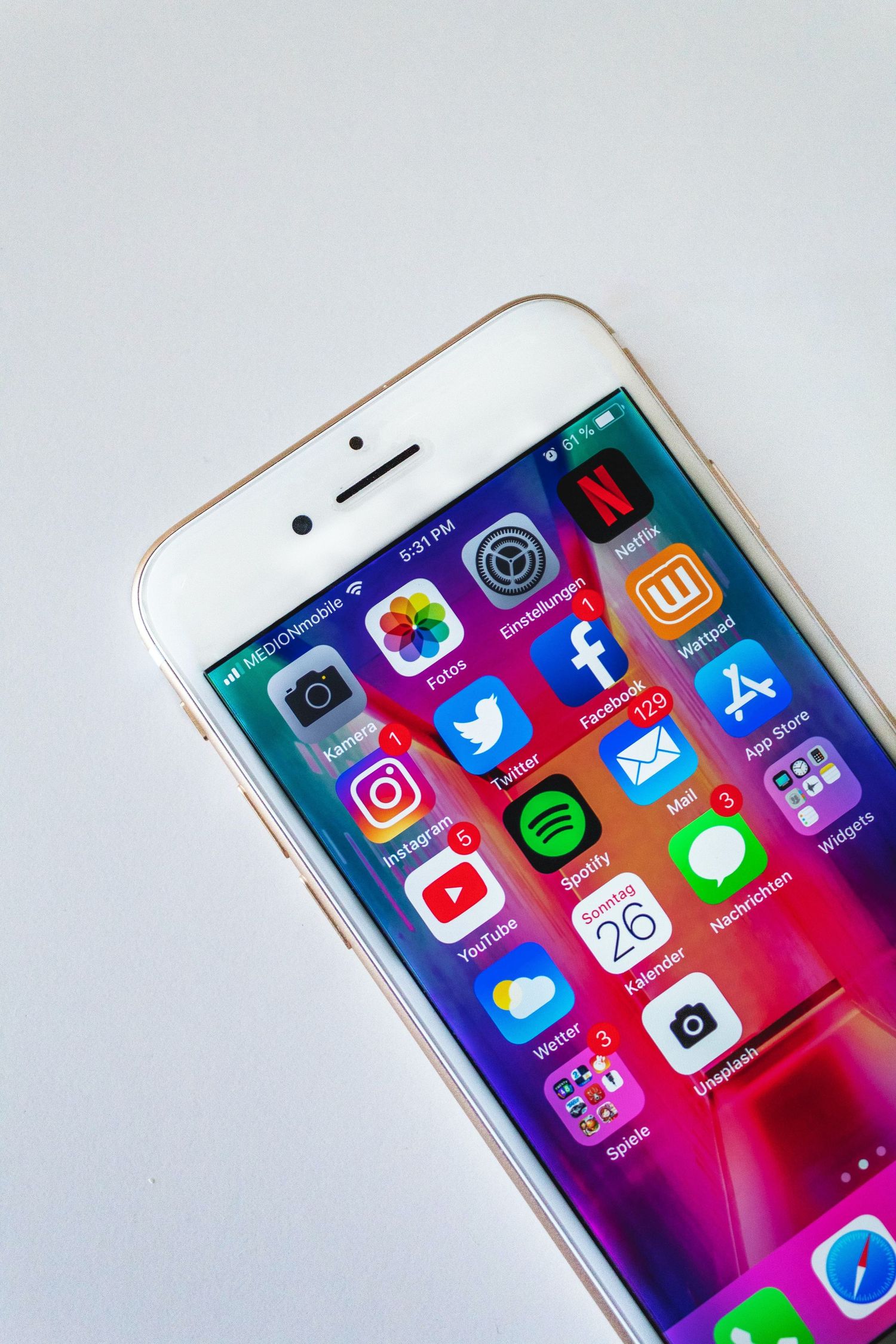 iPhone displaying colorful social media apps including Instagram, Twitter and Facebook.